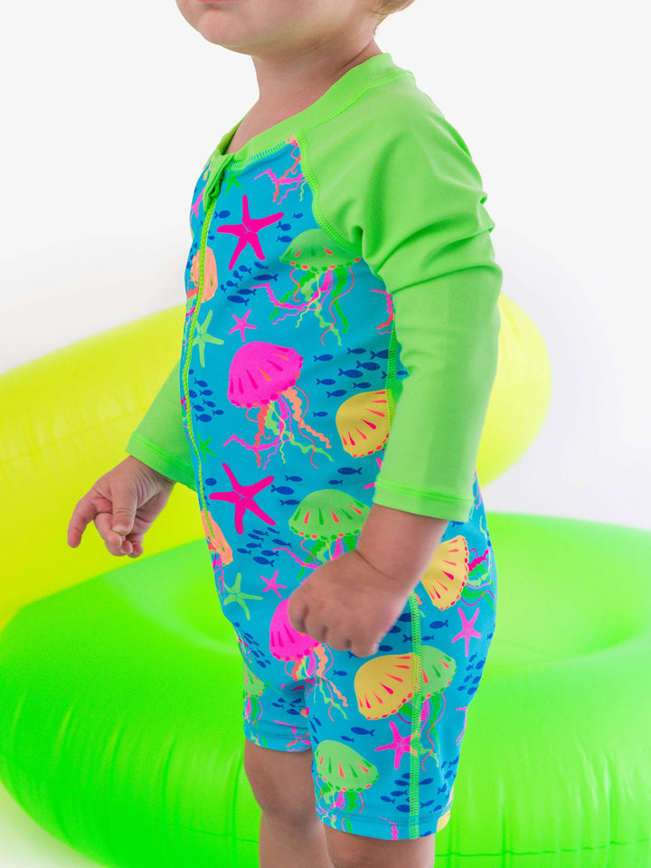 RuffleButts + RuggedButts Long Sleeve One Piece Rash Guard Swimsuit - Neon Jelly Time