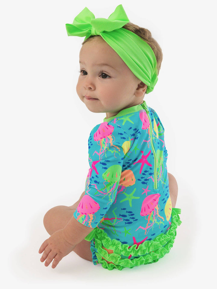 RuffleButts + RuggedButtsLong Sleeve One Piece Rash Guard Swimsuit - Neon Jelly Time